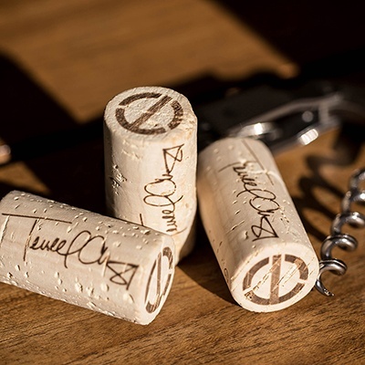Three wine corks are sitting on a table.